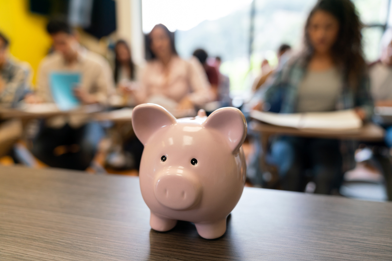 Saving money in a piggybank for education